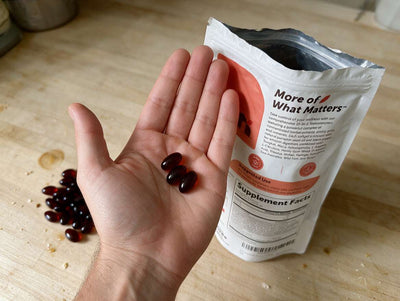 Three softgels in a palm