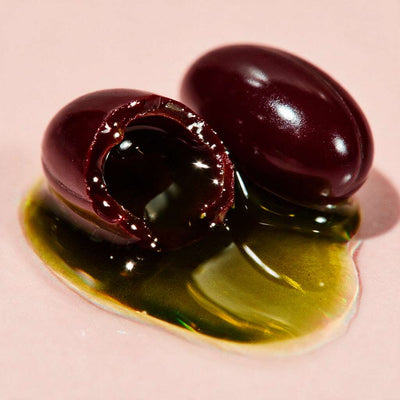 Softgel cut open showing pumpkin seed oil