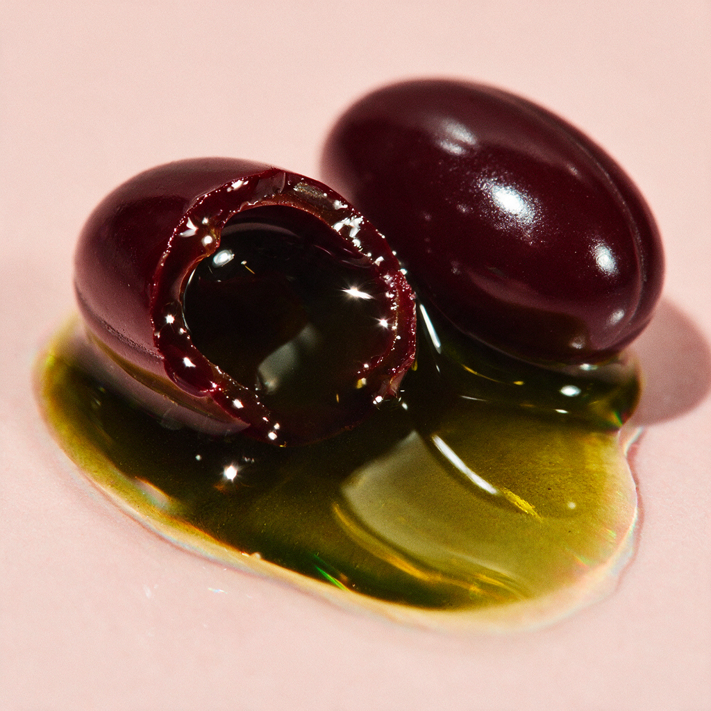 A softgel cut open showing pumpkin seed oil